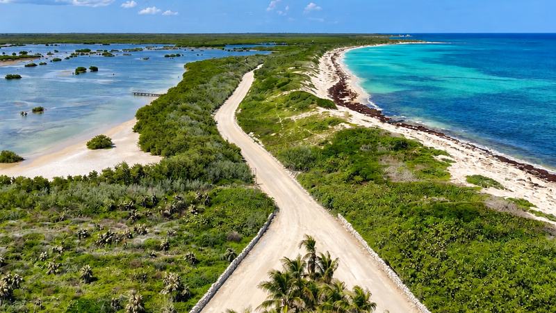 View from the Celarain lighthouse at Punta Sur, Cozumel: the sand road between the Colombia lagoon and the turquoise sea