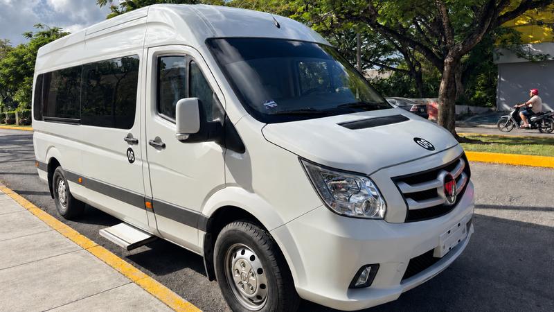 Private air-conditioned van for up to 12 guests, high roof and tinted windows, parked on a Cozumel street
